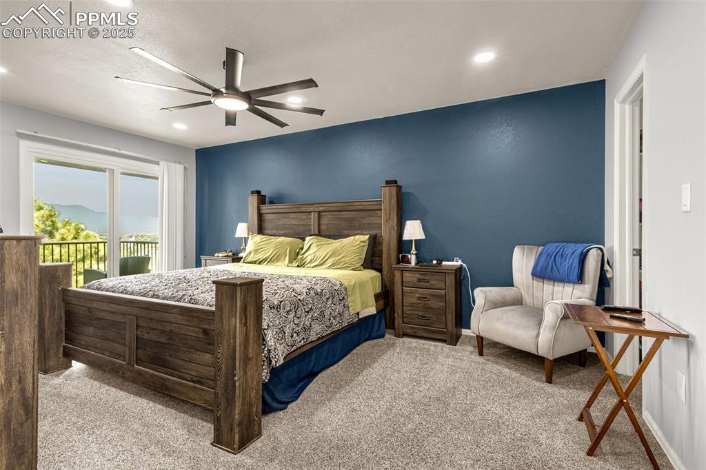 Primary bedroom with private deck, mountian and open space views.