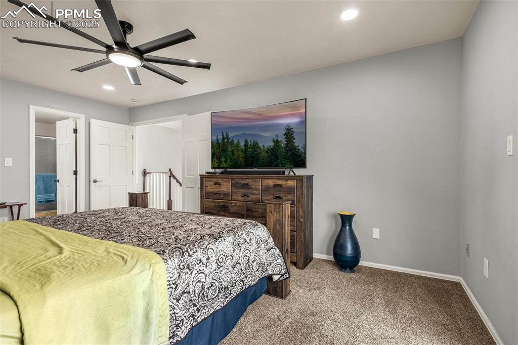 Primary bedroom with private deck, mountian and open space views.