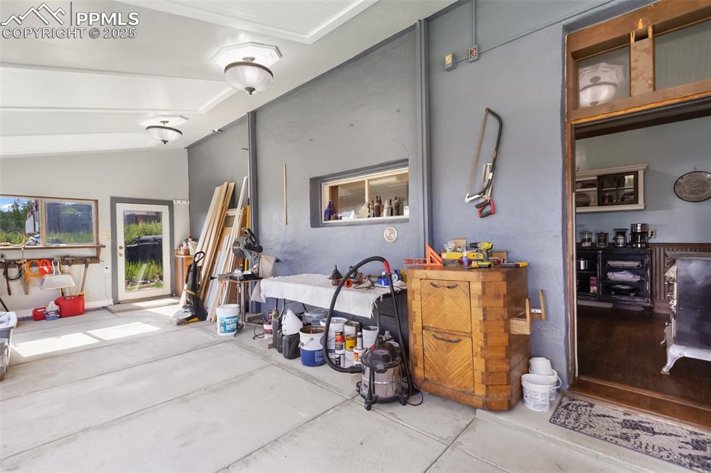 solarium looking from the east to the west, door on the west end directly accesses the back yard. You can see the stove in the kitchen