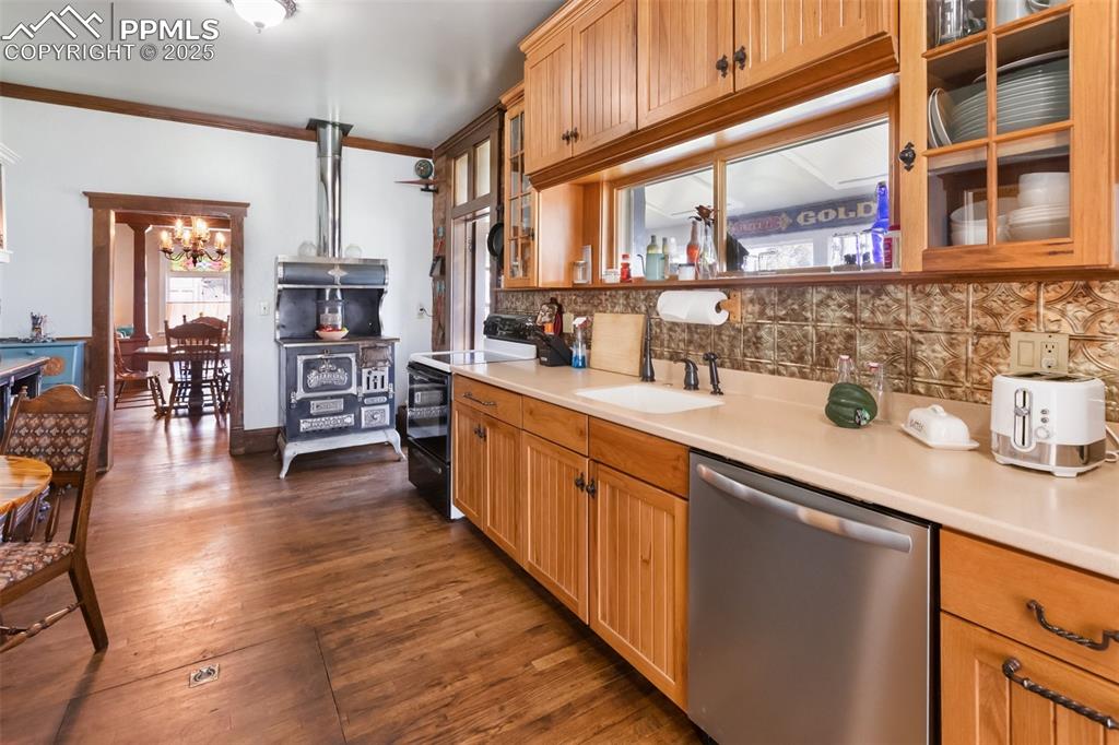 lots of hard surface counter space, lots of high quality wood cabinets providing lot of storage, built in dishwasher, note entry into the Solarium to the right of the coal and wood stove