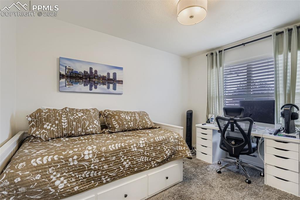 Bedroom featuring carpet floors and an office area