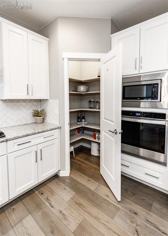 Spacious walk-in pantry provides ample storage and keeps the kitchen organized.
