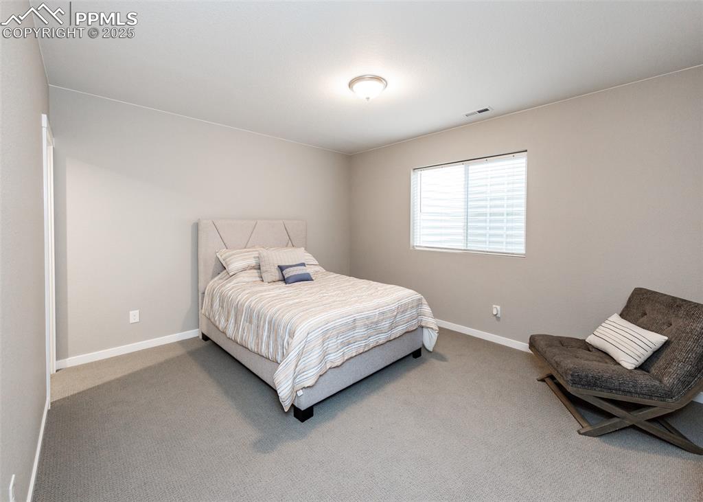 Large basement bedroom offers ample space and flexibility for guests or hobbies.