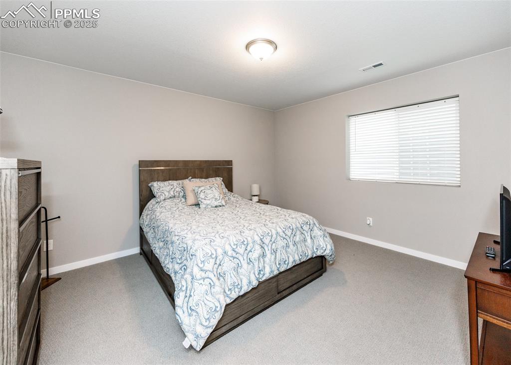 Spacious basement bedroom provides a comfortable retreat with plenty of room for furniture and personal touches.