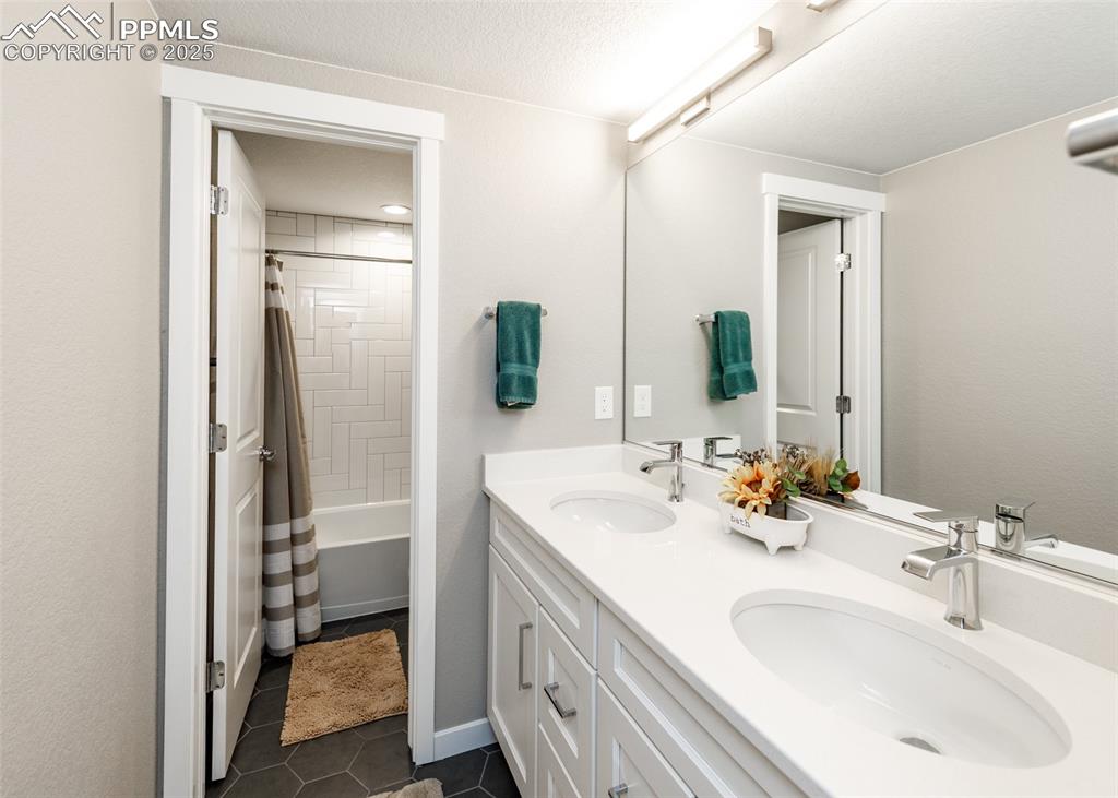 right basement full bathroom with a double vanity, providing ample space for family or guests.