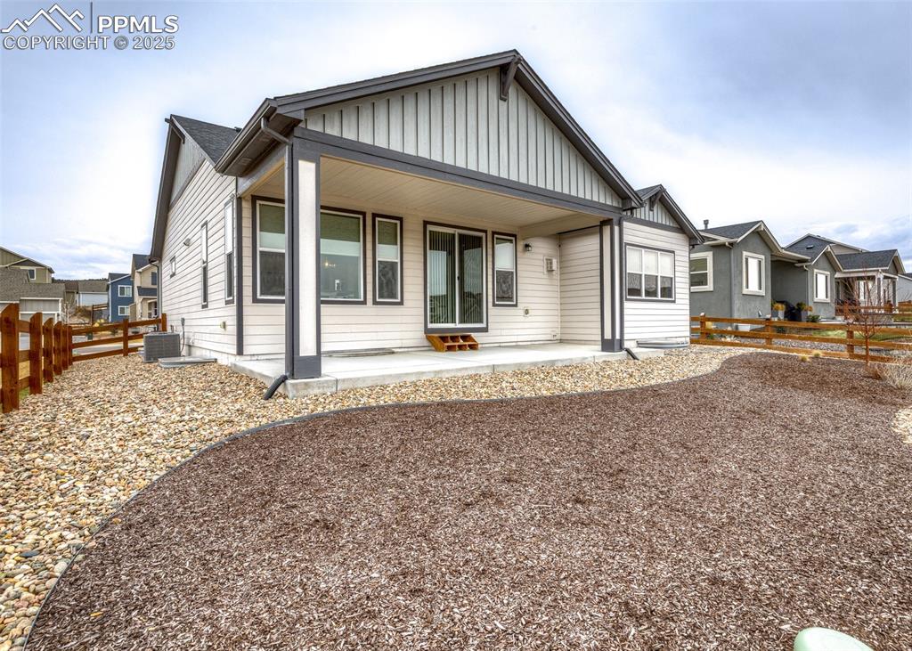 Rear of the home with beautifully landscaped yard great for enjoying Colorado scenery.