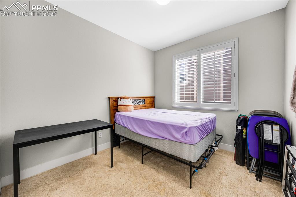 Bedroom featuring light carpet