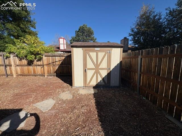 View of shed featuring a fenced backyard