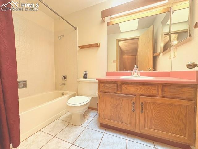 Full bathroom with vanity, light tile patterned floors, and shower / tub combo