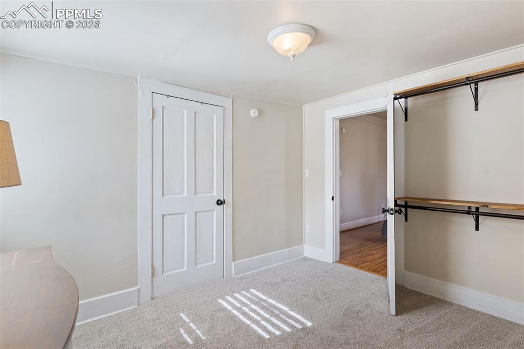 Office/sitting/dressing room off the primary bedroom. Light and bright with closet and hanging racks for clothes.