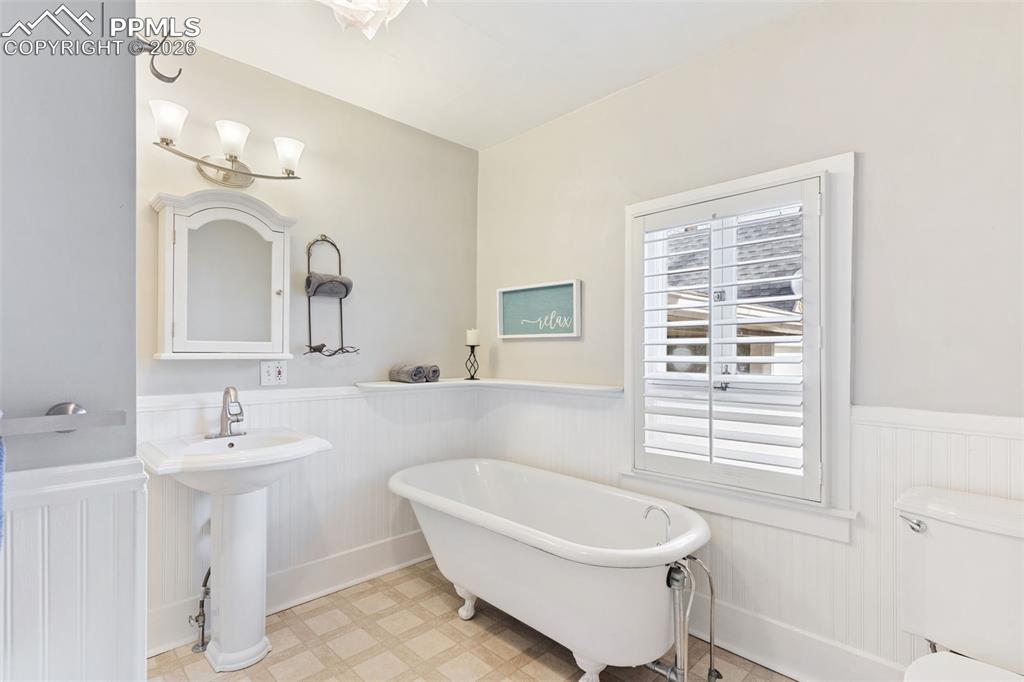Graceful, spacious bathroom with claw foot tub and separate shower.