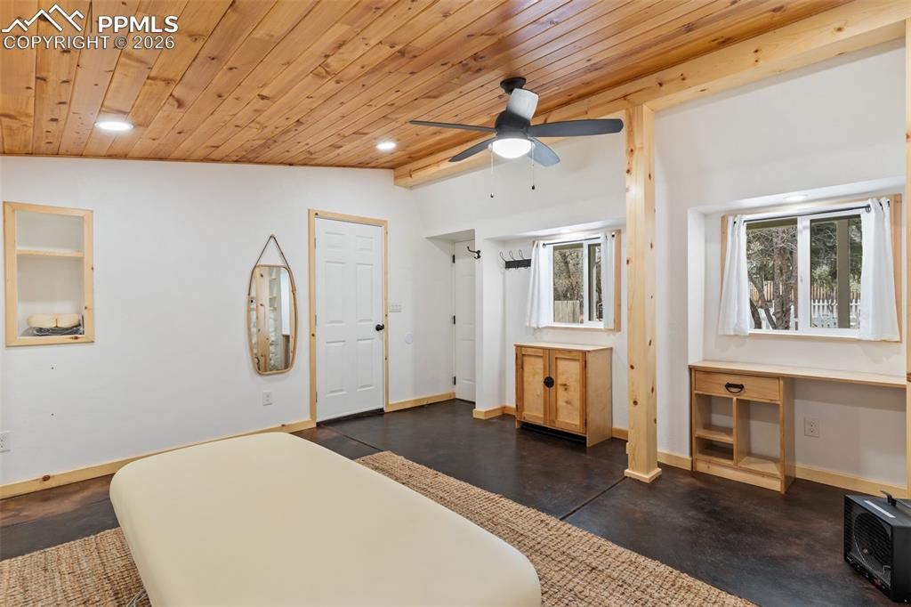 Custom studio is perfect for a home office, business, art room, workshop, etc. Tongue and groove wood ceiling, recessed lighting, beautiful wood accents, stained concrete floor--just beautiful!