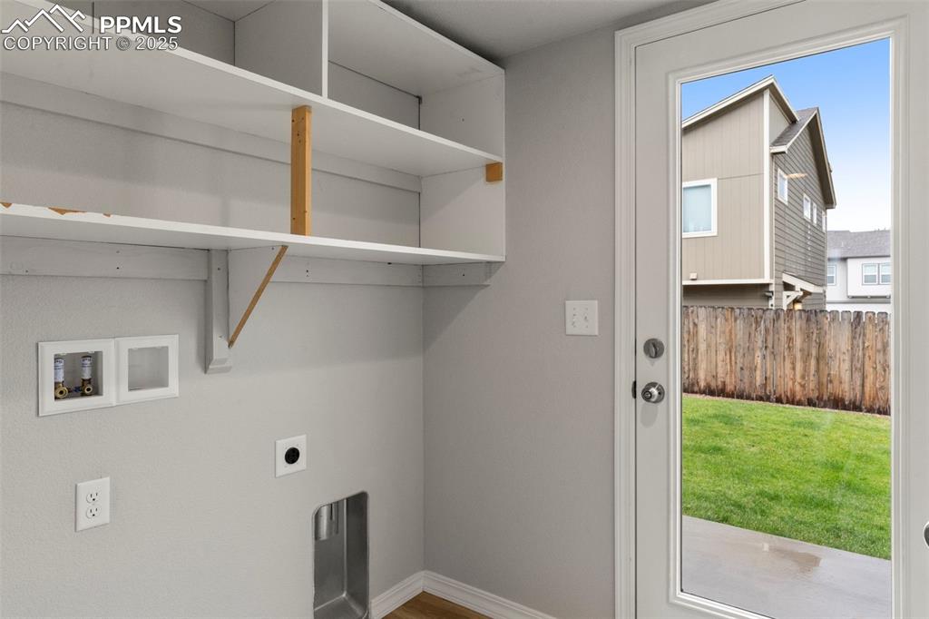 Laundry room featuring electric dryer hookup, hookup for a washing machine, and wood finished floors