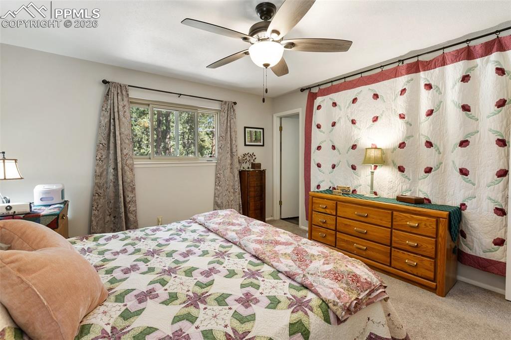 Bedroom featuring a ceiling fan and light colored carpet