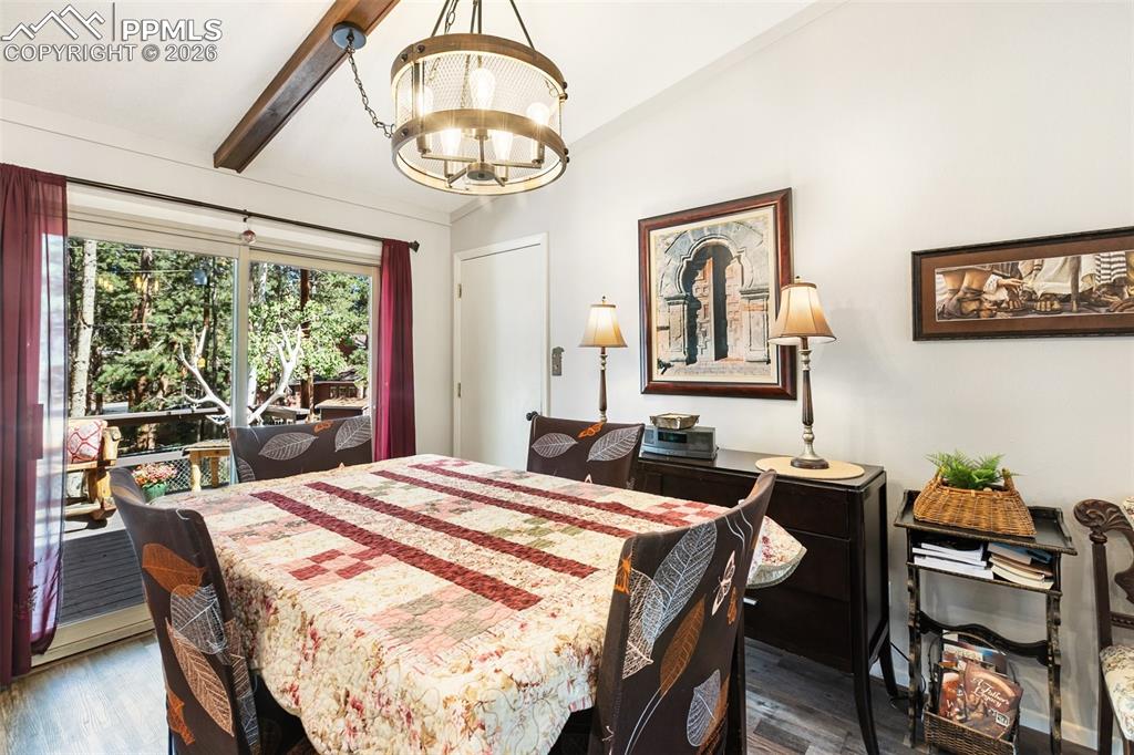 Dining space featuring wood finished floors and a chandelier