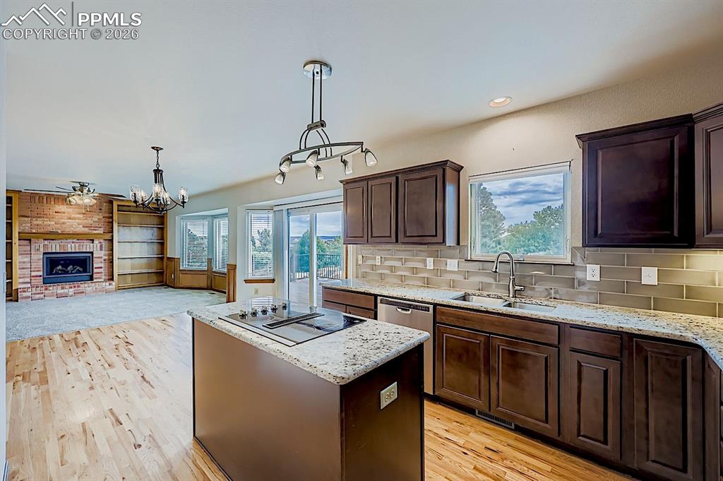 Kitchen featuring a center island, dark brown cabinetry, plenty of natural light, pendant lighting, and recessed lighting