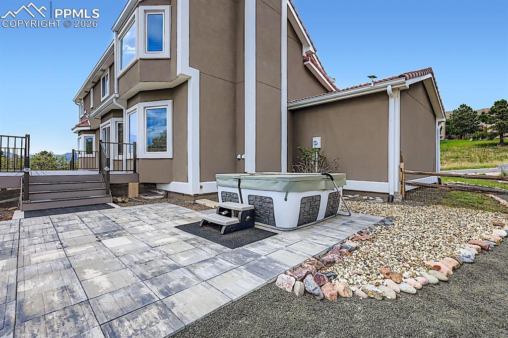 View of patio / terrace featuring a hot tub and a wooden deck