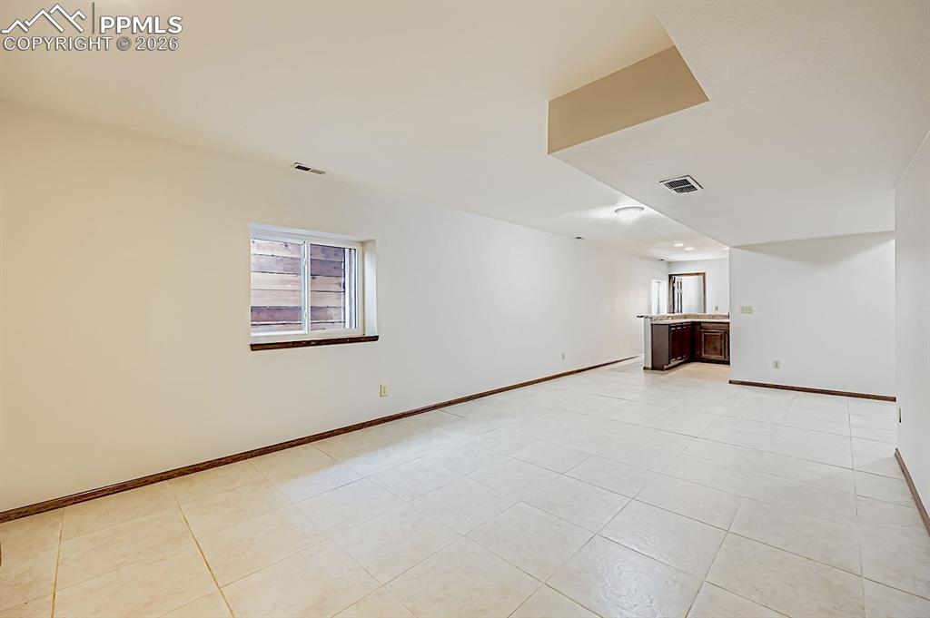 Unfurnished living room with light tile patterned floors