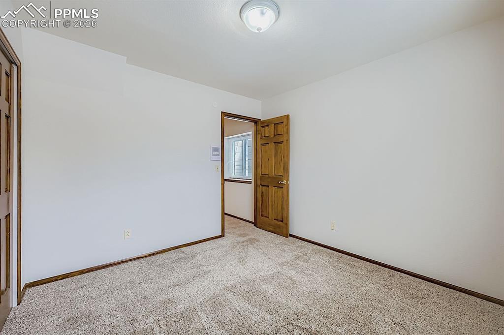 Carpeted spare room with baseboards