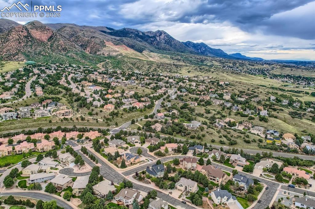 Aerial view of property's location featuring nearby suburban area and a mountainous background