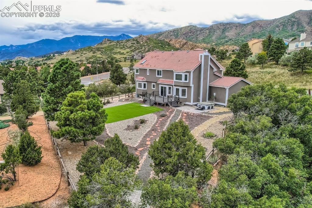 Aerial view of property and surrounding area featuring mountains