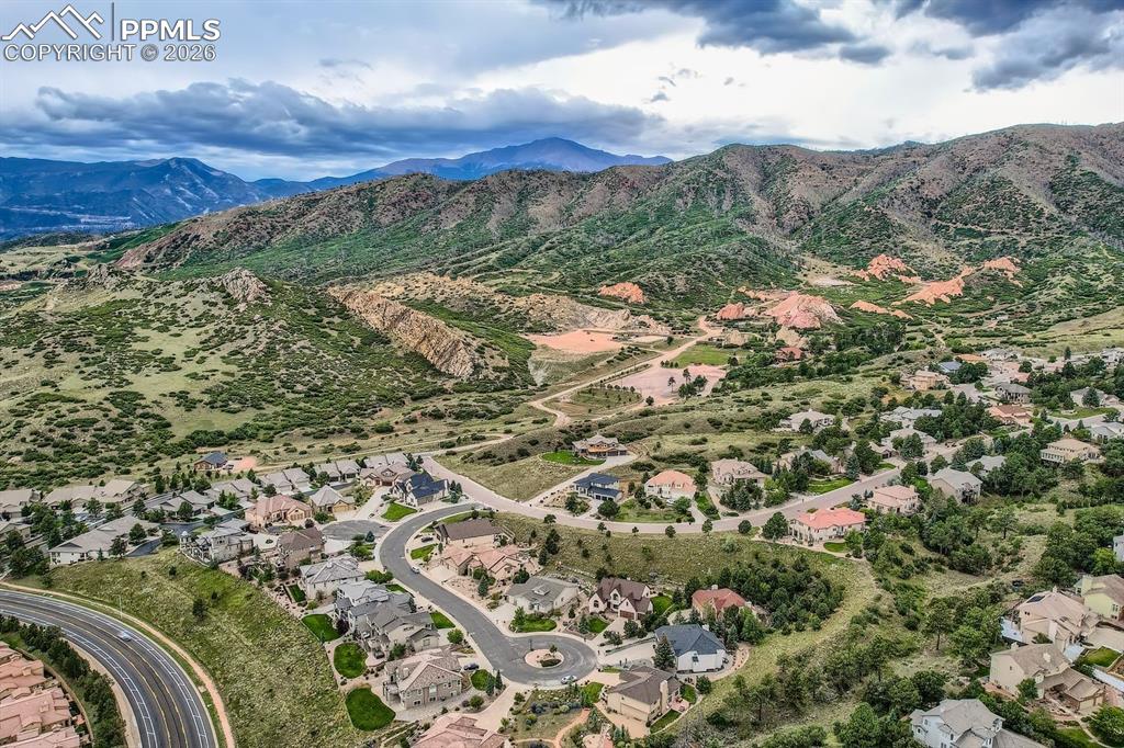 Aerial overview of property's location featuring a mountainous background and nearby suburban area