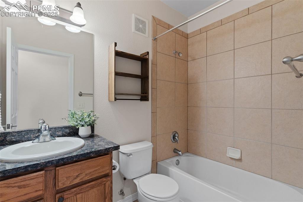 Bathroom featuring shower / washtub combination and vanity
