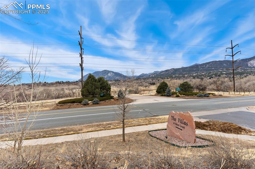 View of asphalt road with a mountain view and sidewalks