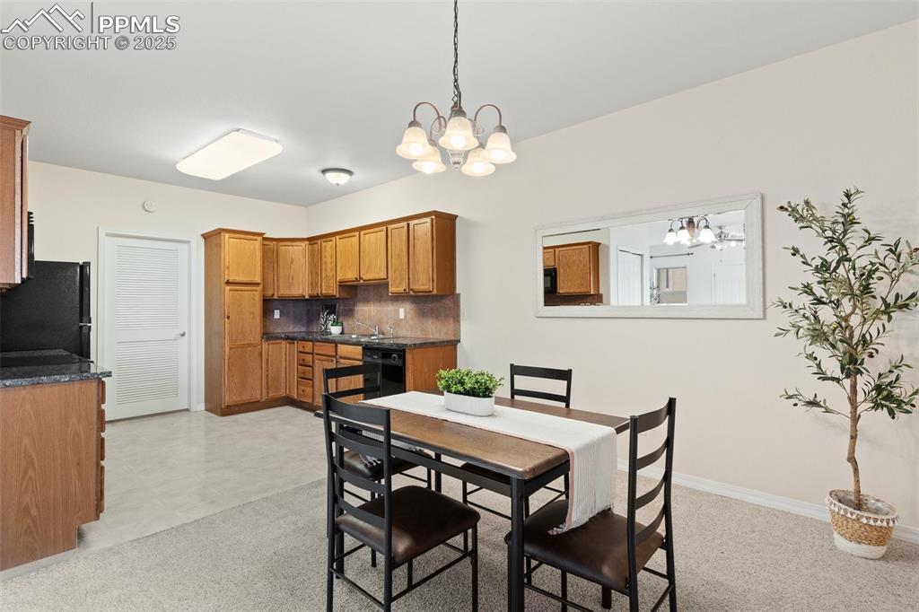 Dining area featuring a chandelier and light carpet