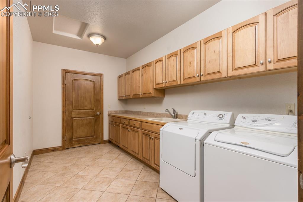 The main level laundry features counter top space, plenty of cabinet storage and wash sink. The perfect mud room!