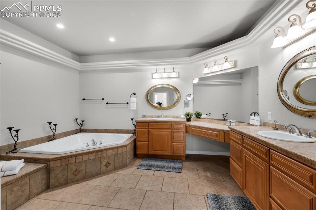 Bathroom with vanity, tile patterned floors, a bath, and recessed lighting