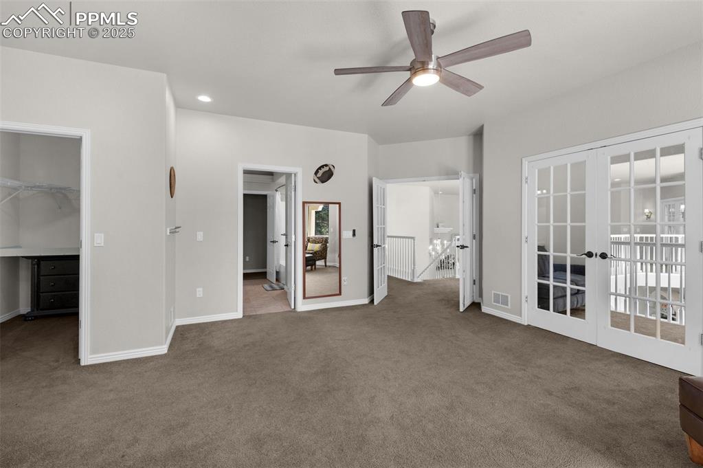 Unfurnished bedroom with a spacious closet, carpet flooring, french doors, and visible vents