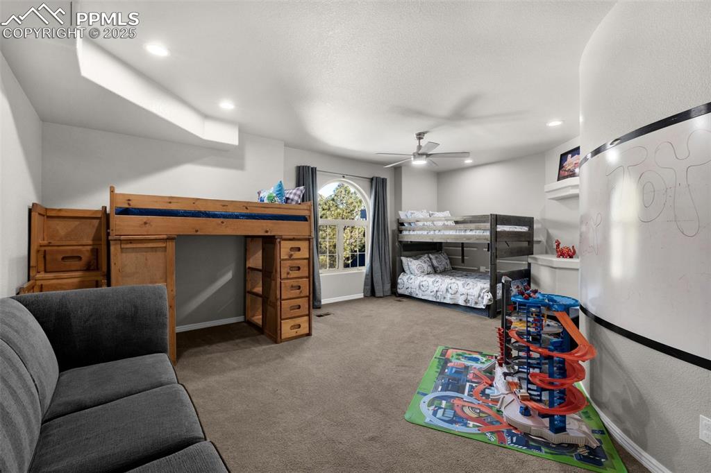 Bedroom featuring recessed lighting, baseboards, carpet, and ceiling fan