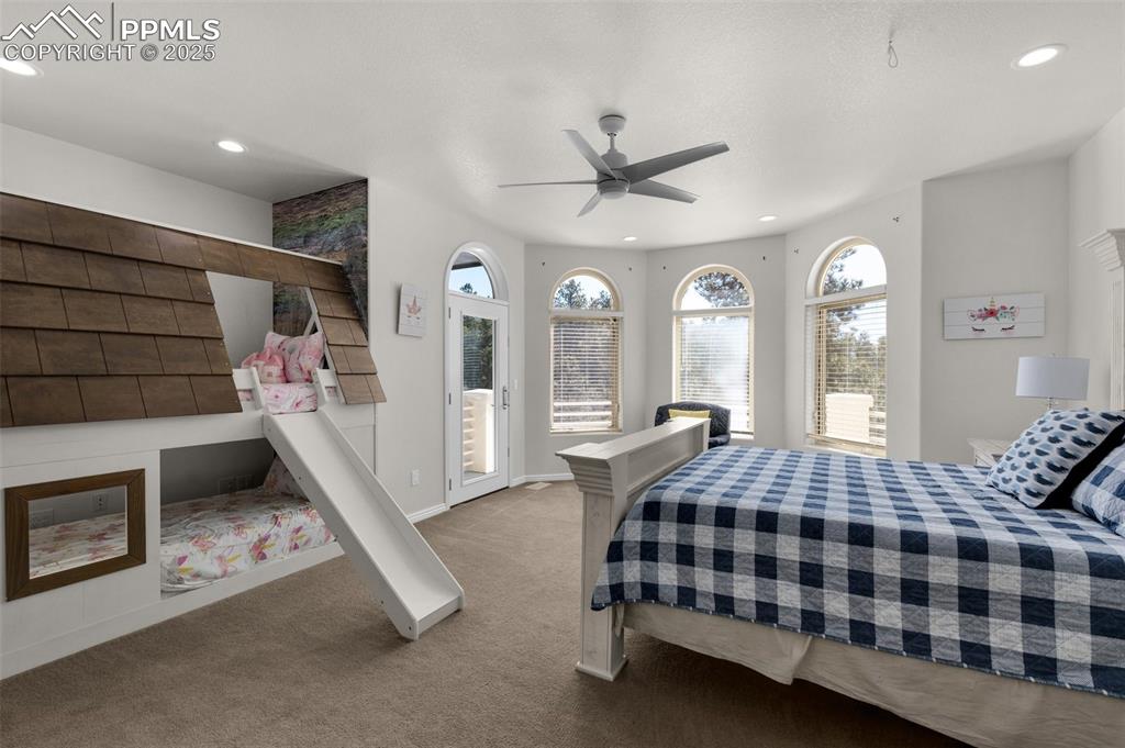 Carpeted bedroom with recessed lighting, baseboards, ceiling fan, and access to outside