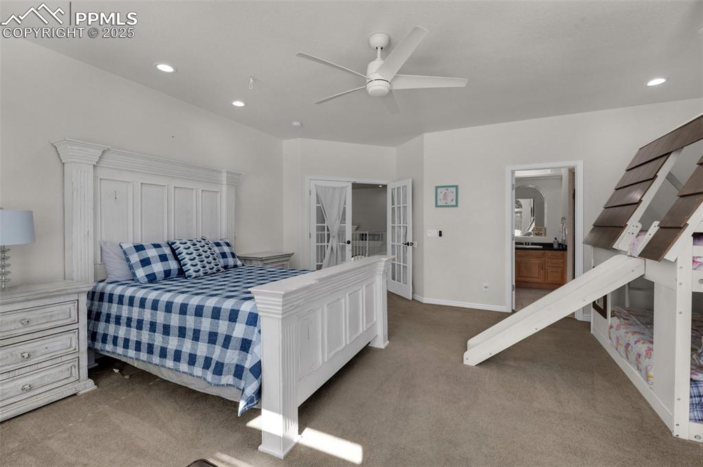 Carpeted bedroom with a ceiling fan, recessed lighting, french doors, and baseboards