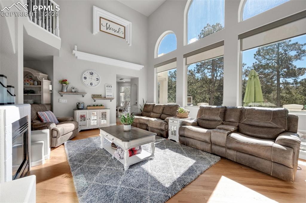 Living room with a towering ceiling and light wood finished floors
