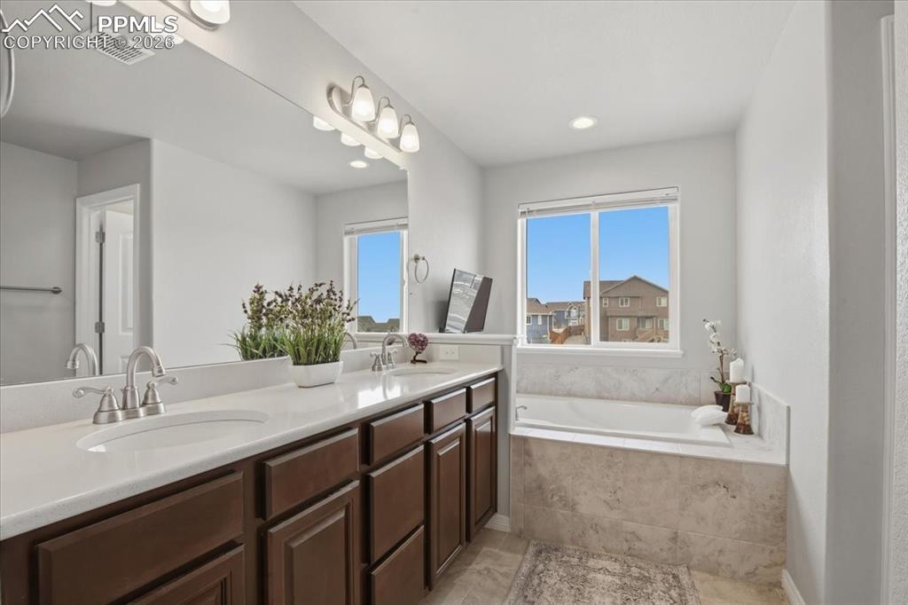 Primary bathroom with double vanity and generous storage