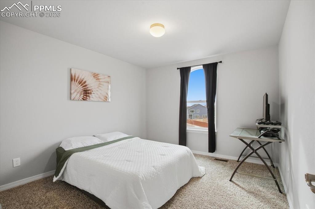 Second floor bedroom with front facing window and natural light 
