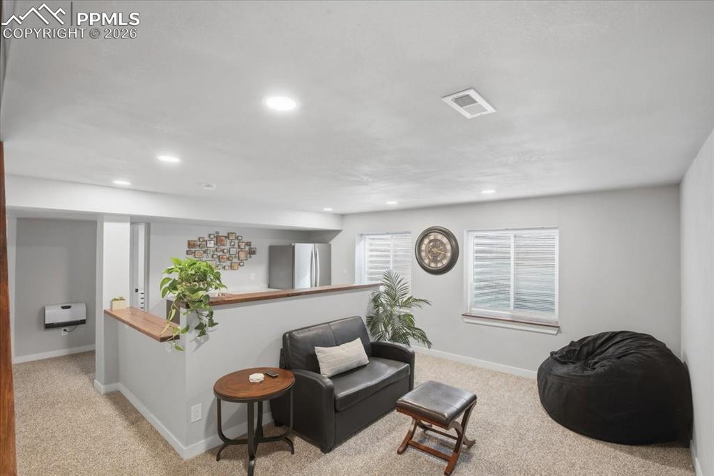 Spacious basement family room with recessed lighting and flexible living space