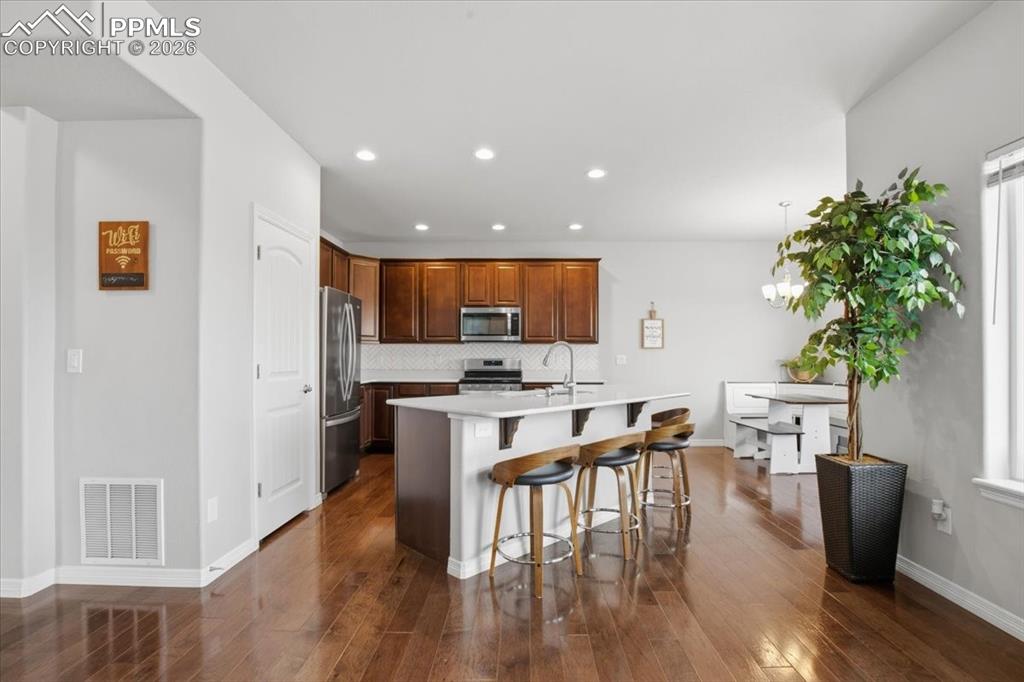 Kitchen with breakfast bar seating and open concept 