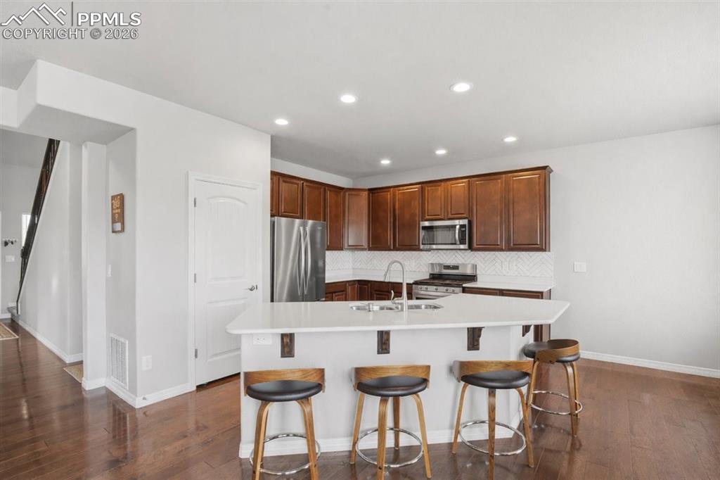 Open kitchen layout connecting seamlessly to dining and living areas