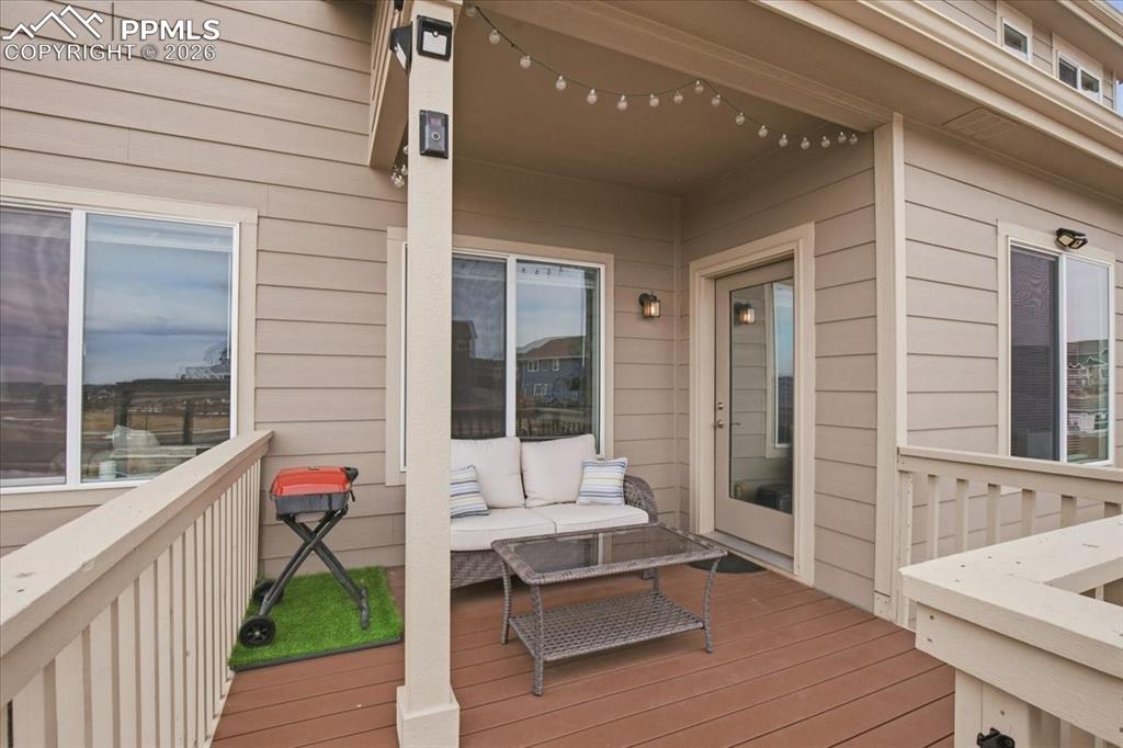 Back deck overlooking the fenced backyard and outdoor living space 