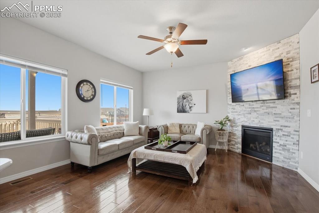 Spacious living room with ceiling fan and seamless flow into the kitchen and dining space