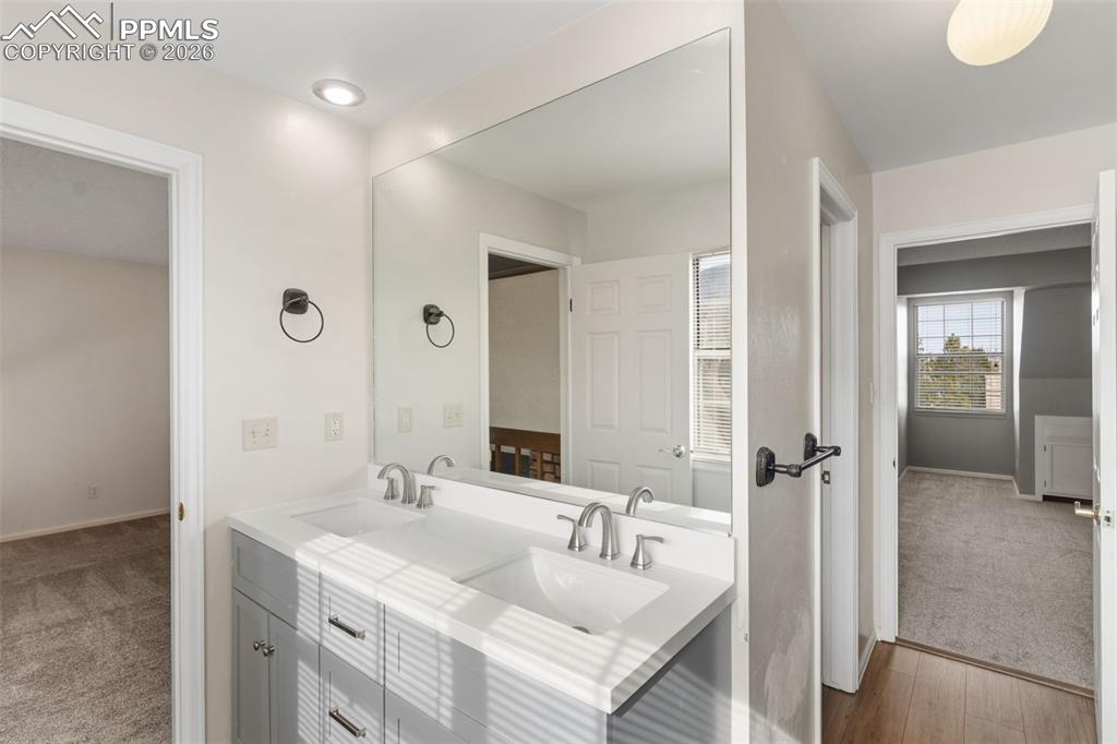 Bathroom featuring double vanity and free-standing shower with barn door