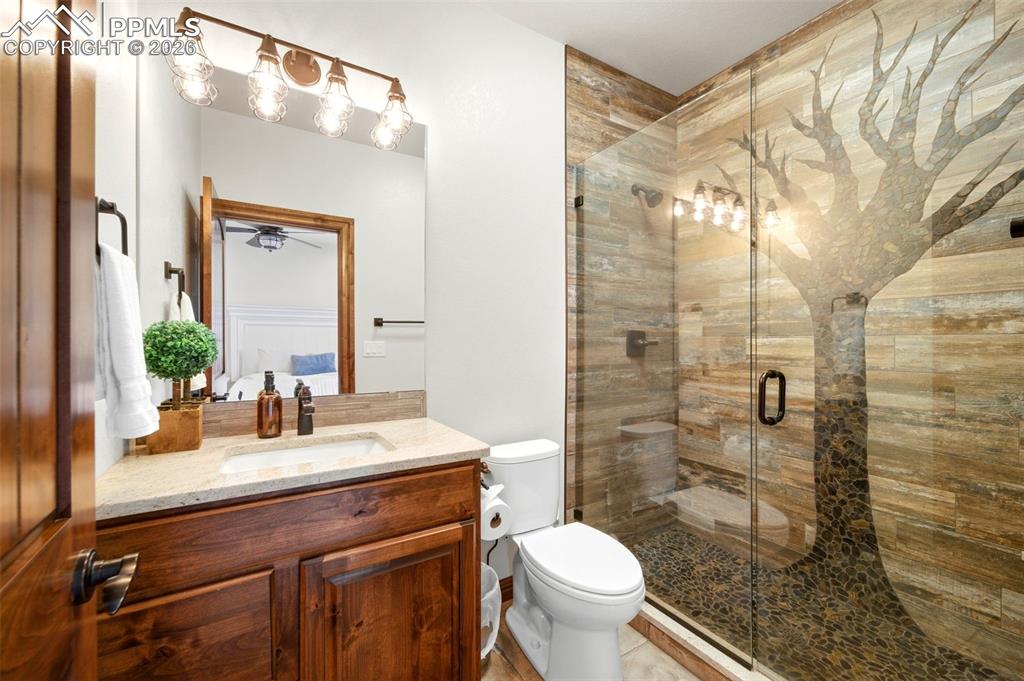 Bathroom featuring vanity and a shower stall