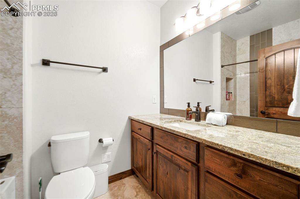 Full bathroom featuring vanity and toilet