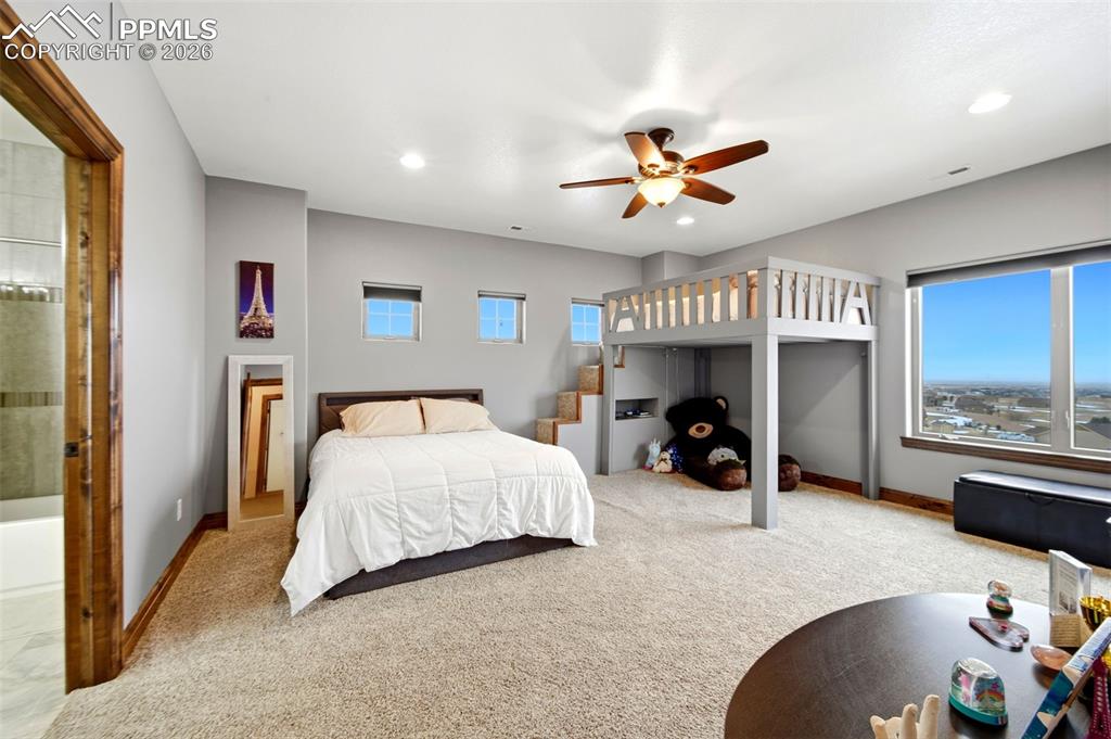 Carpeted bedroom featuring a ceiling fan and recessed lighting