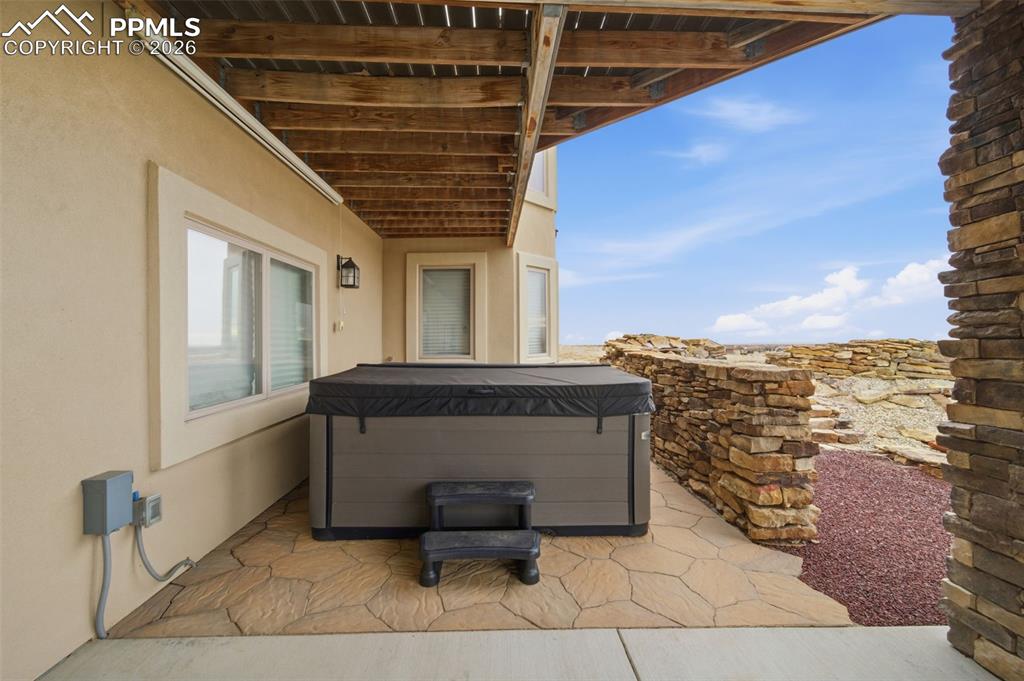 View of patio featuring a hot tub