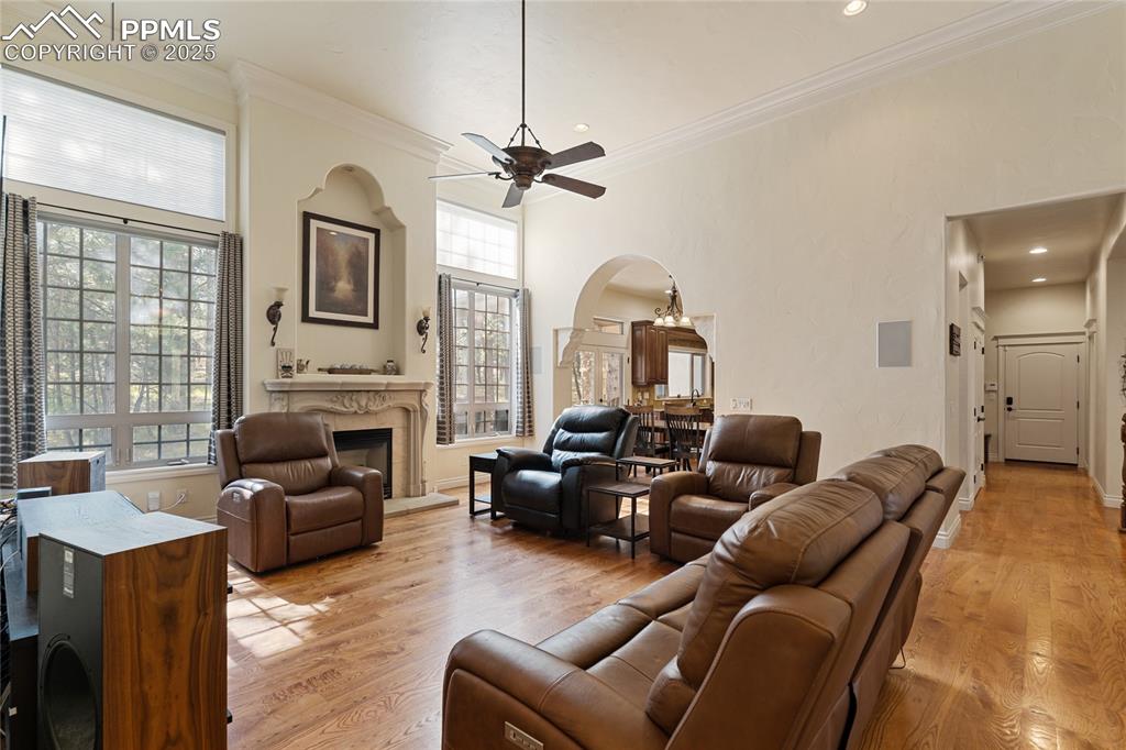 The living room is the heart of the home with 12' + ceilings, a fireplace, hardwood floors