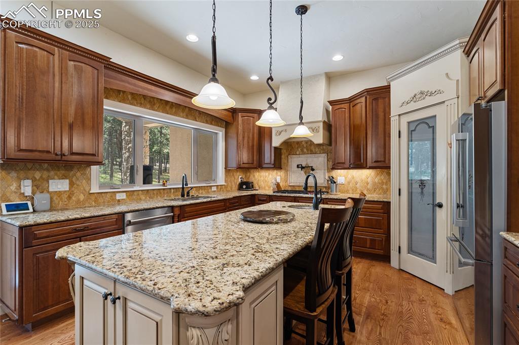 A pantry, stone counter tops, and more views of the pines.